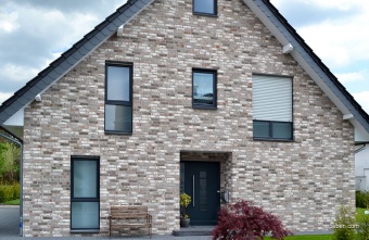 Фасад из кирпича ручной формовки Roben GEESTBRAND светло серый. На фронтонах: Eternit Dacora.